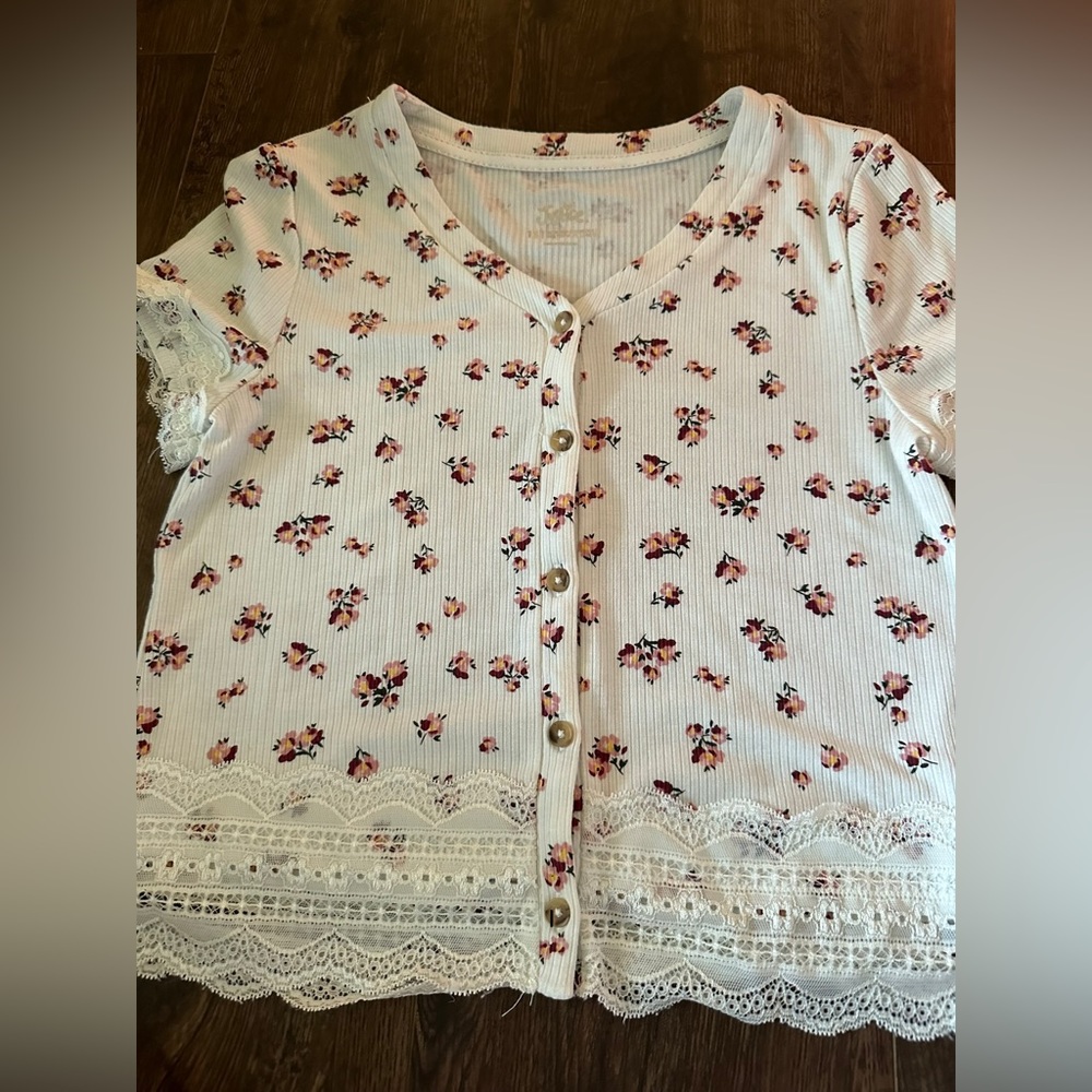 White and pink floral shirt, kind of a crop top